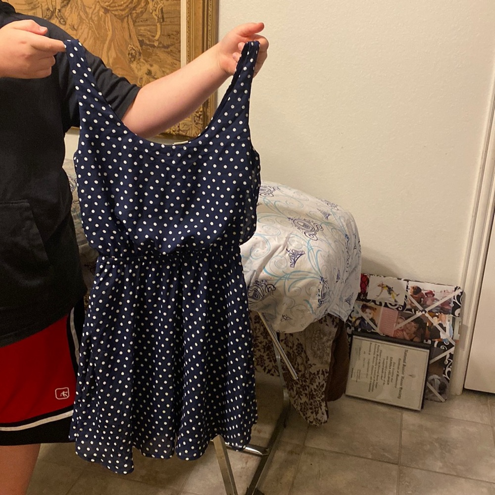 a blue dress with white polka dots